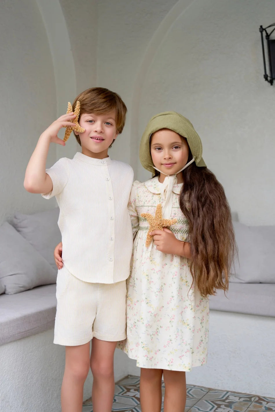 طقم ملابس عائلي متناسق للأولاد والبنات من مجموعة "AS SS26 meadow collection" باللون الأصفر الفاتح، فستان شموس بالورود للبنات وتطريز سموكنج للأولاد مخطط.